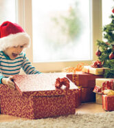 Surprised little boy opening Christmas present. Surprised little boy opening Christmas present.